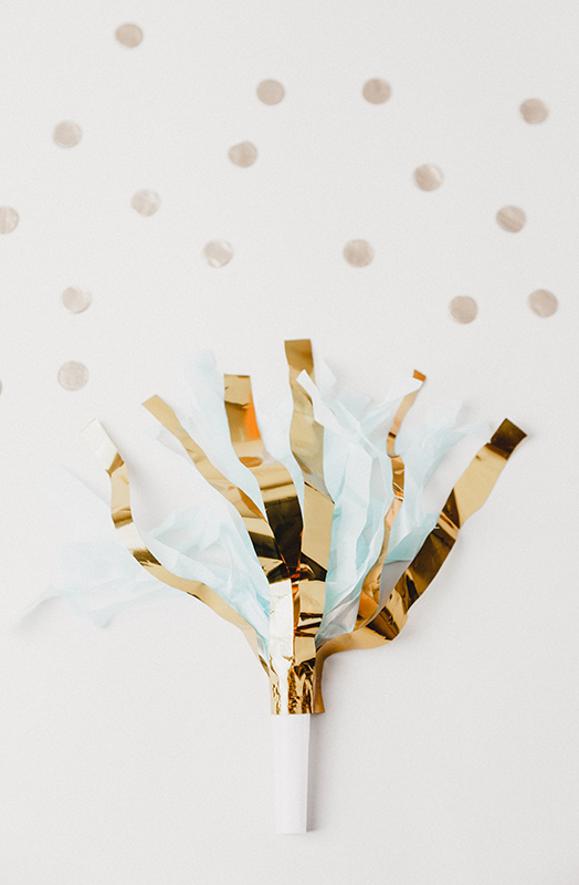White and golden foil party decor on white panel
