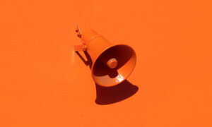 Orange loudspeaker on an orange wall
