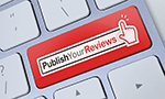 Image of white keys on a silver keyboard, one of the keys is red and shows the Publish Your Reviews logo.