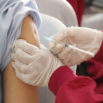 Photograph of a school-aged child being vaccinated