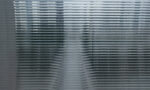 Photograph of a landscape, seen through a ribbed glass pane