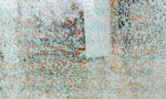 Photograph of a shattered glass window.