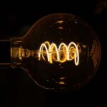 Transformative agreements in Brazil: necessary progress or increased dependence? Photograph of a light bulb lit in a dark environment